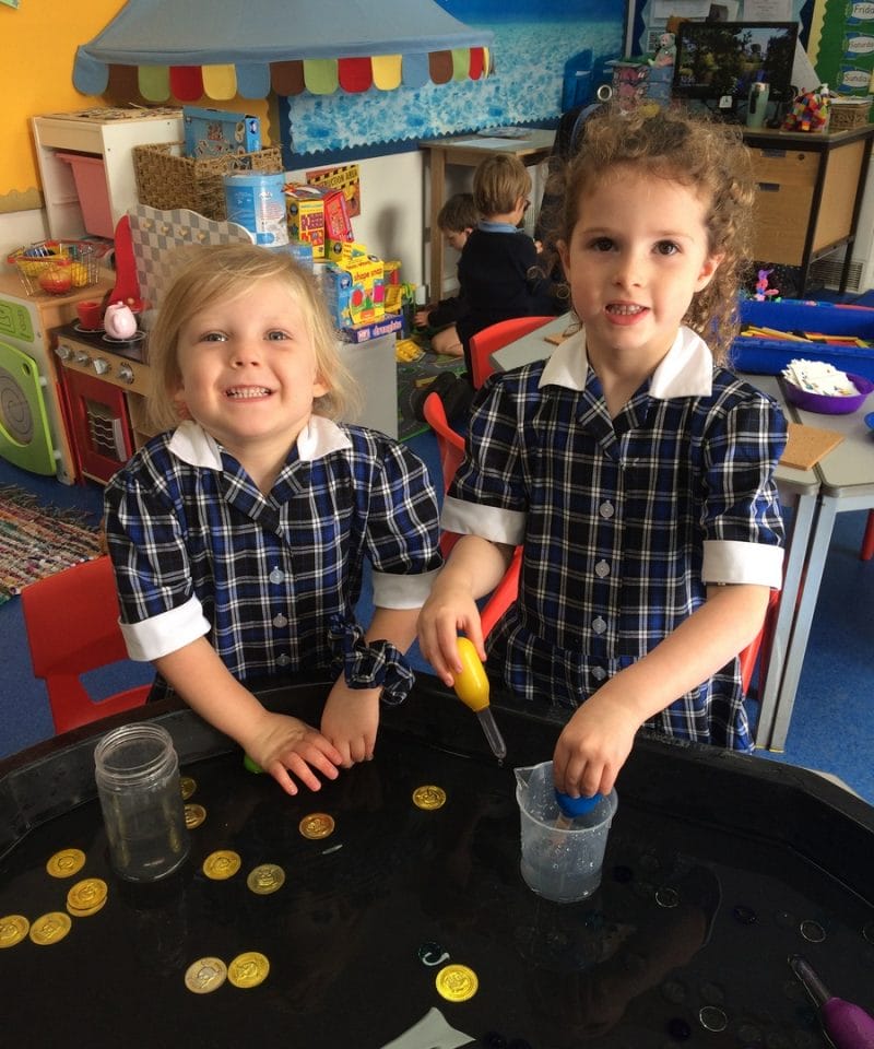 Pinewood Early Years girls playing with water