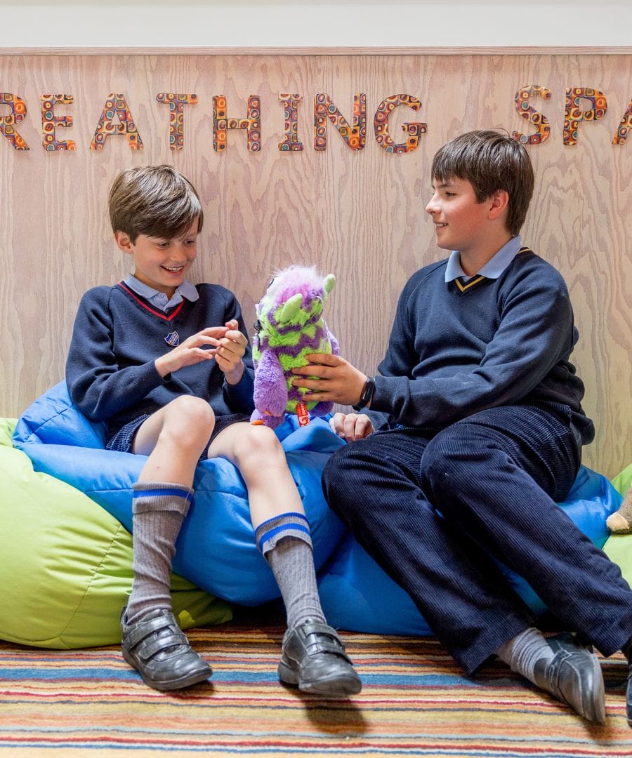 Two boys sat on bean bags at the Pinewood School Wellbeing Area, the Nest
